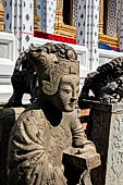 Bangkok Wat Arun - Detail of the precint of the sacred area of the ubosot with chinese noble woman sitting on chair. 